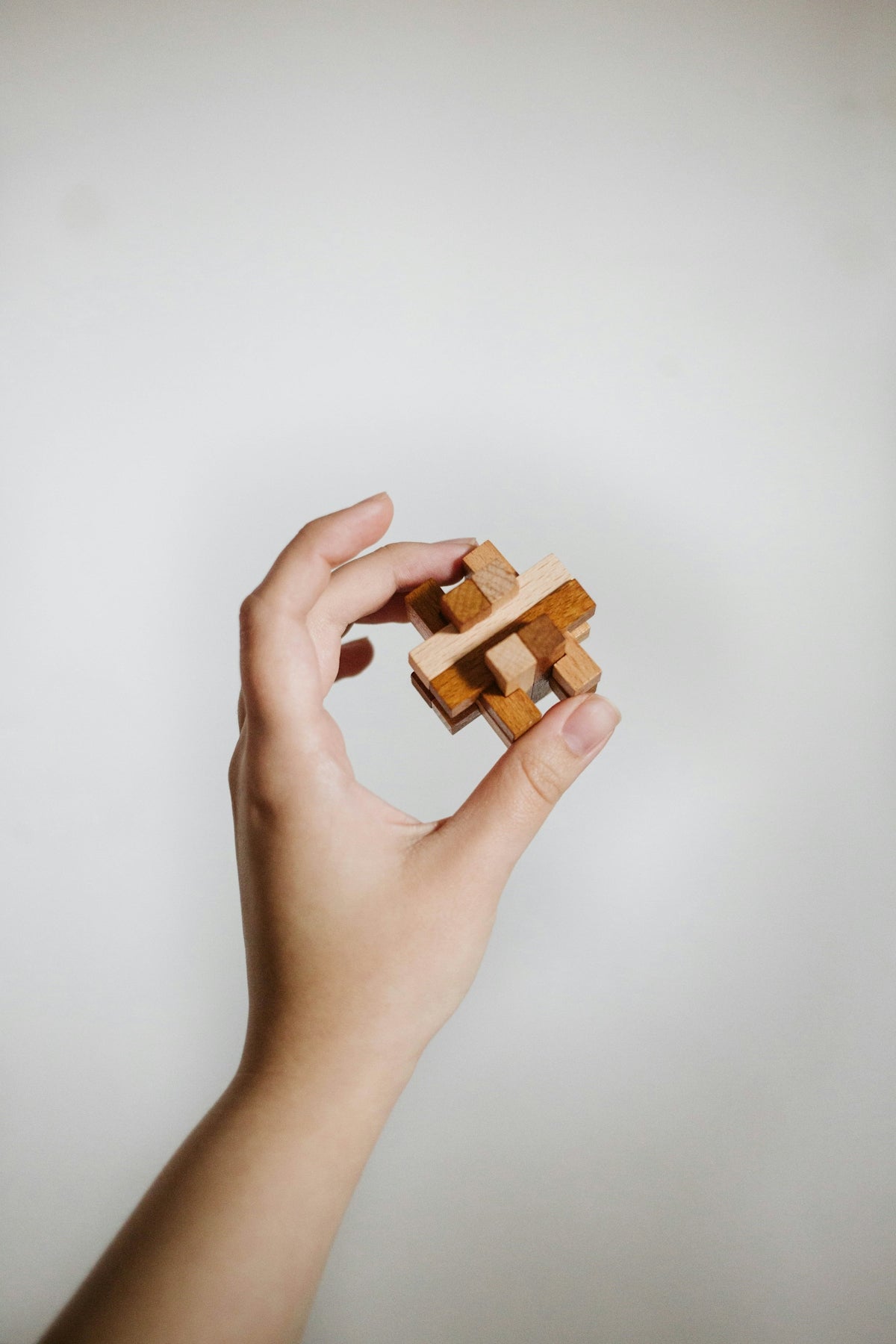 a person holding a wooden block in their hand