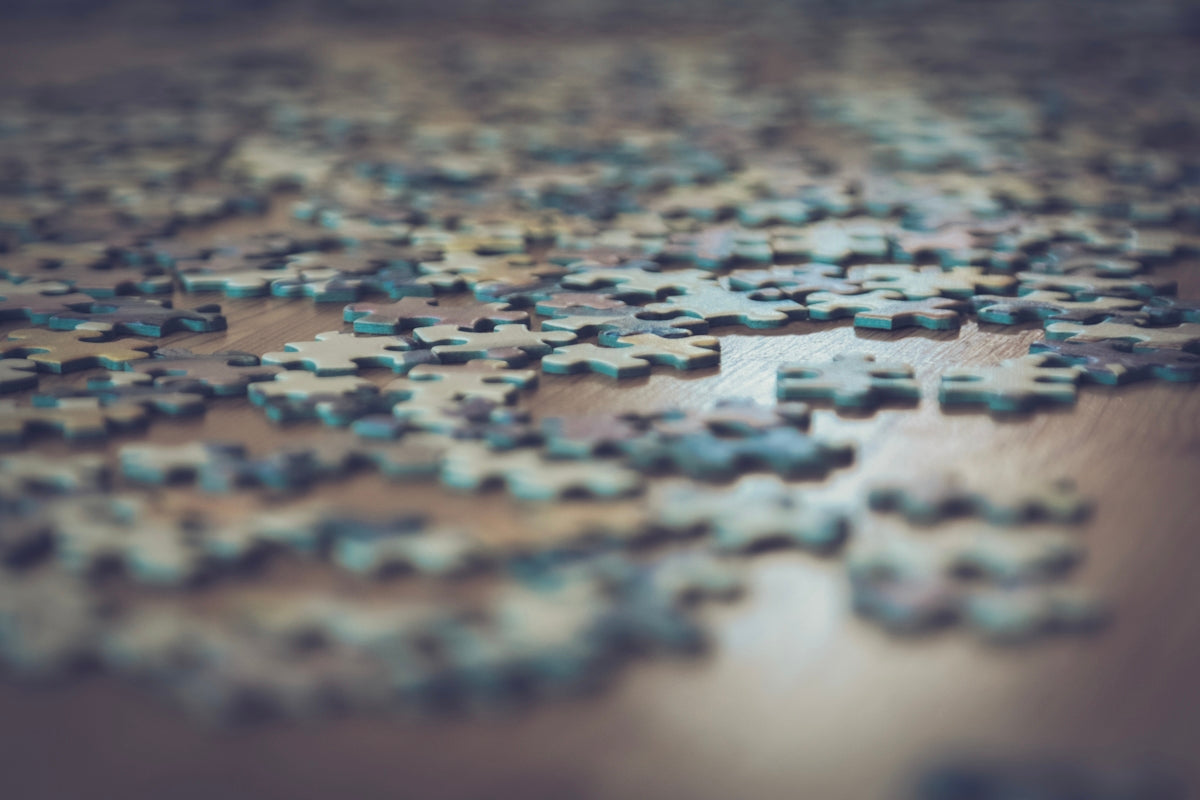 a close up of a puzzle piece on a table