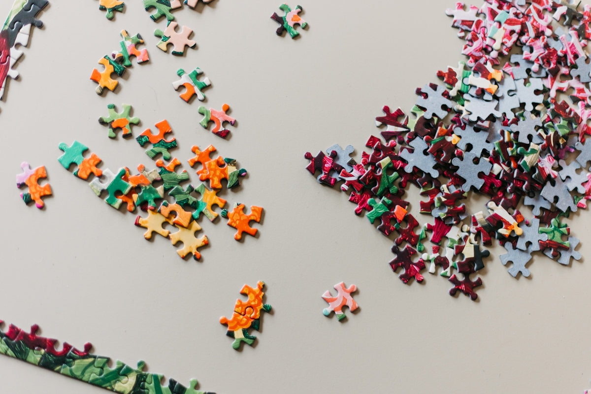A large group of puzzle pieces on a table